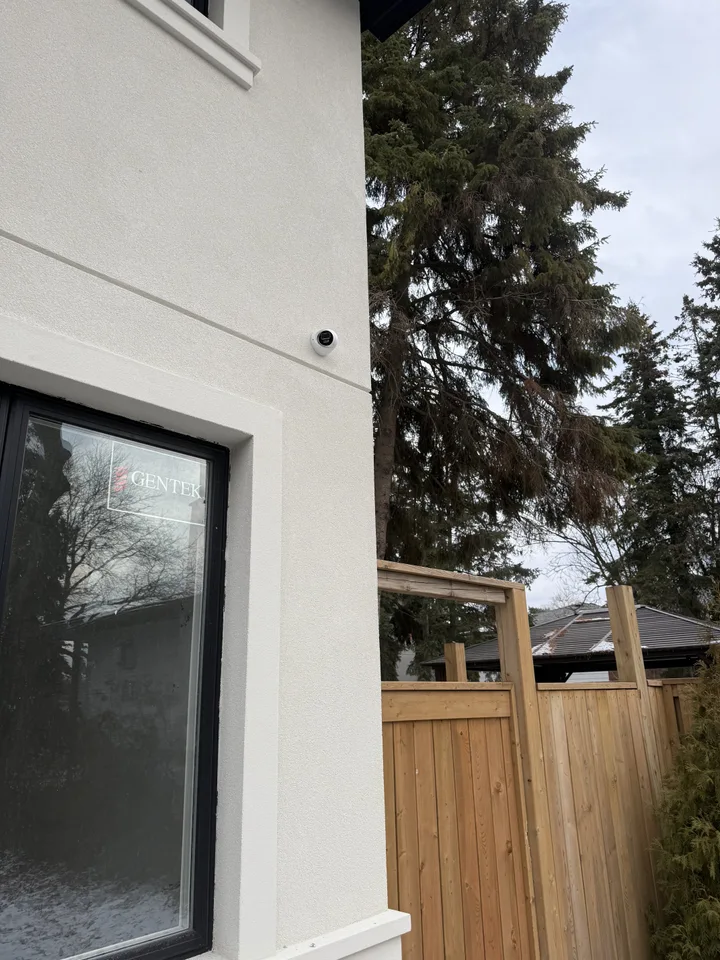 High-end CCTV installation — side-mounted residential security camera on GTA luxury home, fully hidden conduit